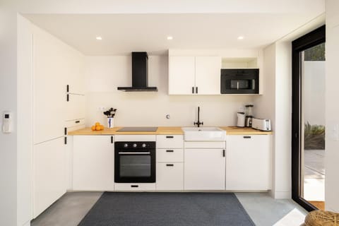 Kitchen or kitchenette, dishwasher, oven, stove