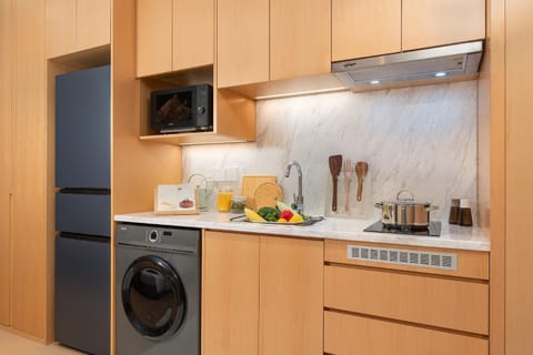 Kitchen or kitchenette, microwave, stove, washing machine