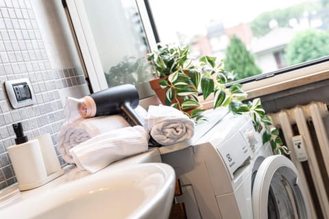 Bathroom, hair dryier, towels, washing machine