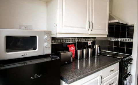 Kitchen or kitchenette, microwave, oven, stove