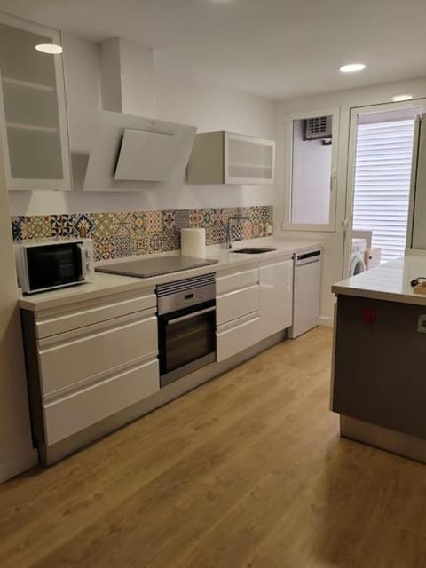 Kitchen or kitchenette, dishwasher, oven, stove