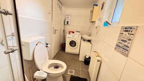 Shower, Toilet, Bathroom, bidet, towels, washing machine, dryer