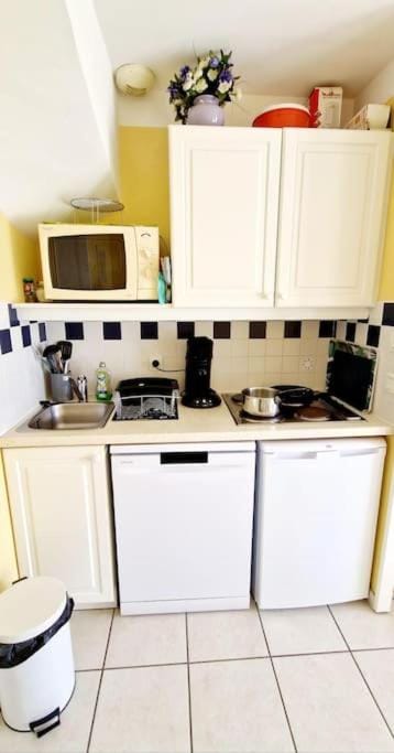 Kitchen or kitchenette, dishwasher, oven, stove, toaster