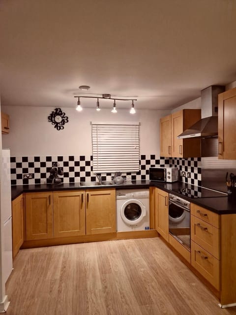 Kitchen or kitchenette, microwave, oven, stove, washing machine