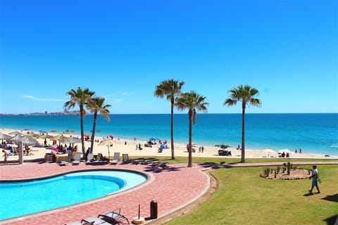 Beach, Swimming pool, group of guests, sunbed