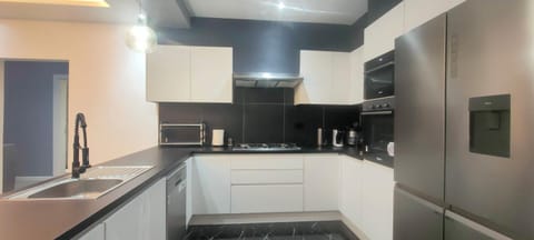 Kitchen or kitchenette, dishwasher, oven, stove