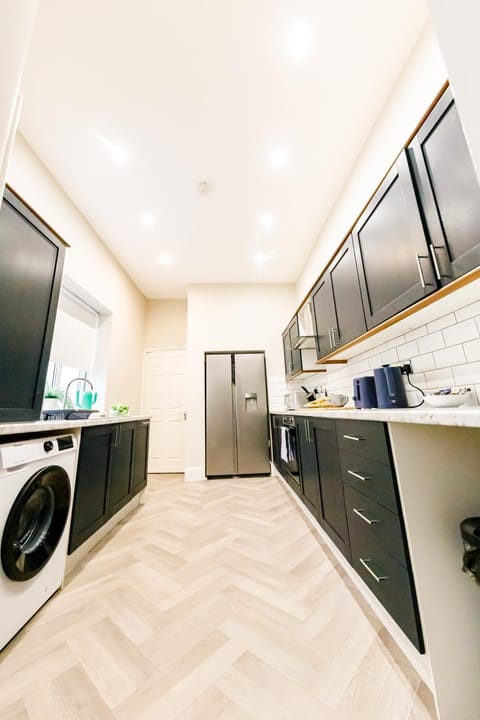 Kitchen or kitchenette, dishwasher, oven, stove, washing machine