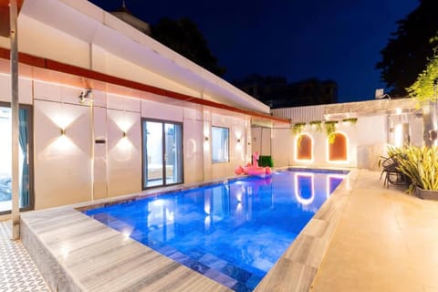 Property building, Patio, Night, Pool view, Swimming pool, Swimming pool, sunbed