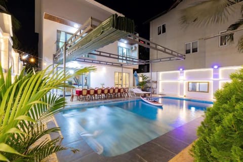 Property building, Patio, Night, Pool view, Swimming pool, Swimming pool, sunbed