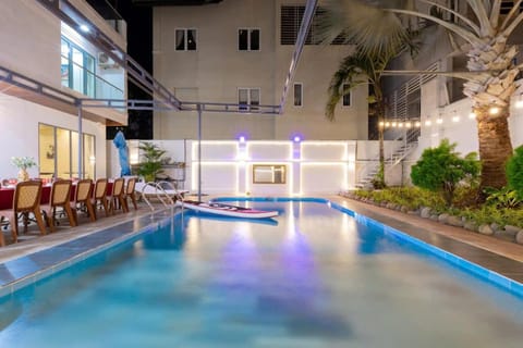 Property building, Patio, Night, Pool view, Swimming pool, Swimming pool, sunbed