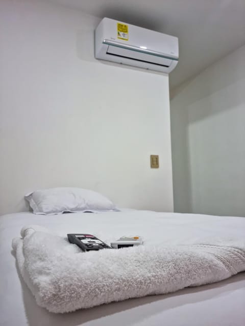 Bed, towels, air conditioner