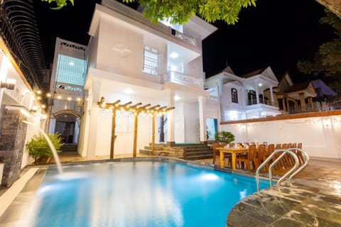 Property building, Patio, Night, Pool view, Swimming pool, sunbed