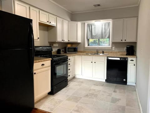 Kitchen or kitchenette, dishwasher, oven, stove