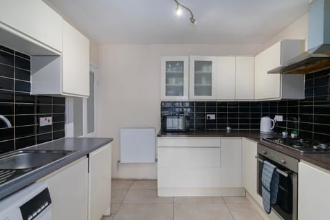 Kitchen or kitchenette, dishwasher, oven, stove, washing machine