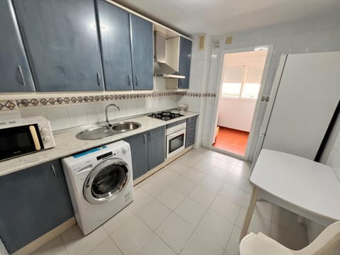 Kitchen or kitchenette, oven, stove, washing machine