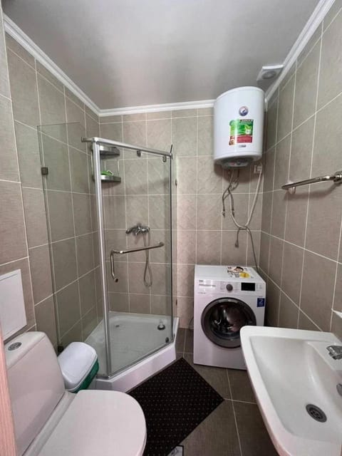 Shower, Toilet, Bathroom, towels, washing machine, dryer