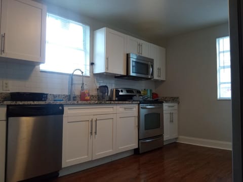 Kitchen or kitchenette, dishwasher, oven, stove