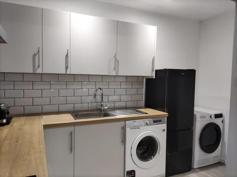 Kitchen or kitchenette, dishwasher, oven, stove, washing machine, dryer