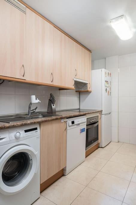 Kitchen or kitchenette, dishwasher, oven, stove, washing machine