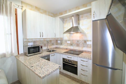 Kitchen or kitchenette, dishwasher, oven, stove