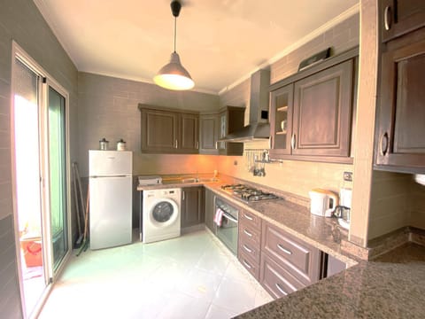 Kitchen or kitchenette, oven, stove, washing machine