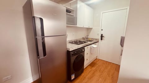 Kitchen or kitchenette, microwave, stove, washing machine, dryer