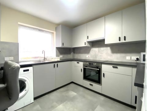 Kitchen or kitchenette, oven, stove, toaster, washing machine, dryer