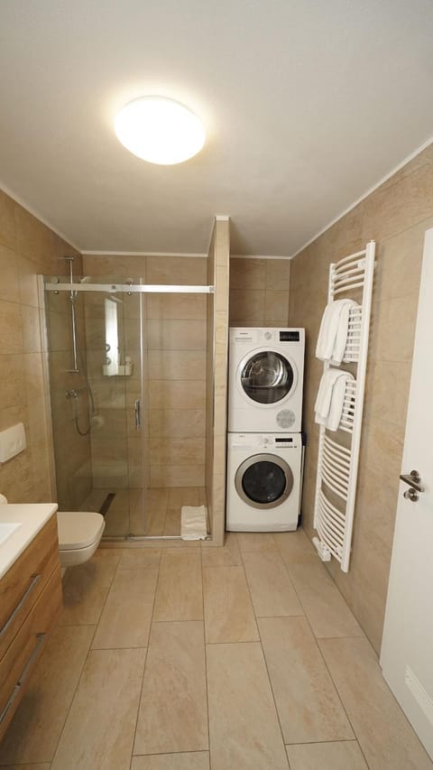 Shower, Toilet, Bathroom, towels, washing machine, dryer