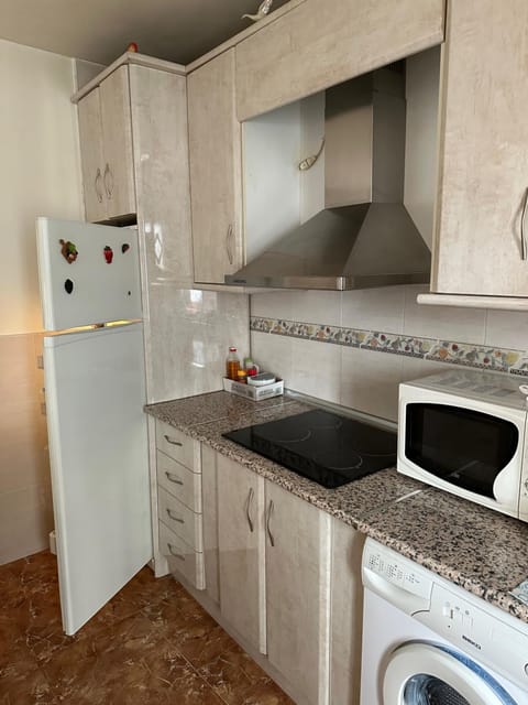 Kitchen or kitchenette, stove, washing machine