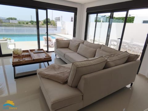 View (from property/room), Living room, Seating area, Pool view, Swimming pool