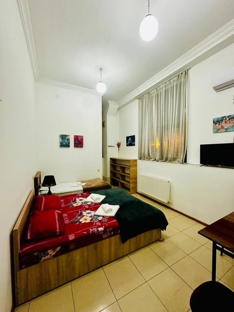 Bed, TV and multimedia, Living room, Seating area, Bedroom, towels, air conditioner