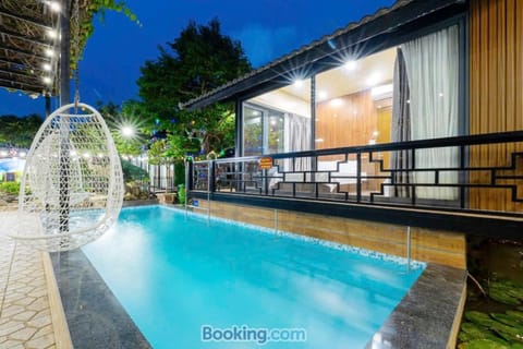 Property building, Patio, Night, Pool view, Swimming pool, sunbed