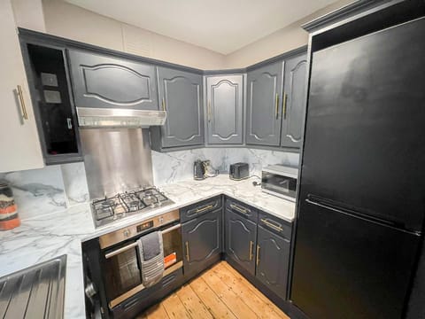 Kitchen or kitchenette, dishwasher, oven, stove