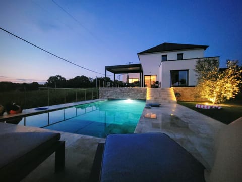Property building, Patio, Night, Pool view, Swimming pool, Swimming pool, sunbed