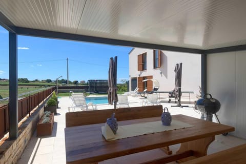 Property building, Patio, Day, BBQ facilities, View (from property/room), Balcony/Terrace, Seating area, Dining area, Pool view, Swimming pool, sunbed