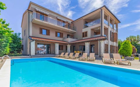 Property building, Patio, Pool view, Swimming pool, sunbed