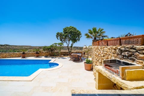 Property building, Patio, Day, Natural landscape, Pool view, Swimming pool, sunbed