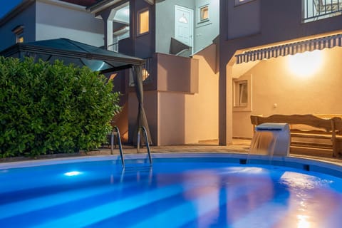 Property building, Patio, Night, Pool view, Swimming pool, sunbed