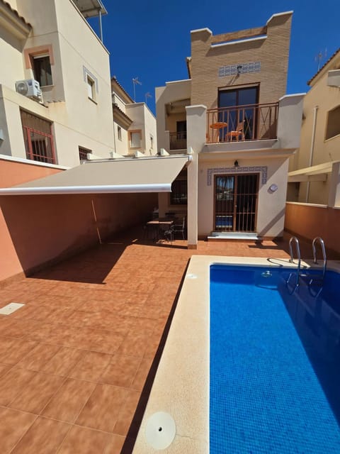 Property building, Patio, Pool view, Swimming pool, sunbed