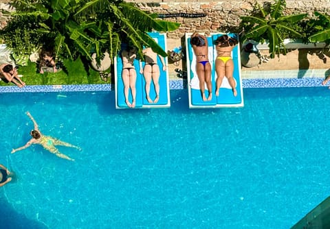 Swimming pool, group of guests, sunbed