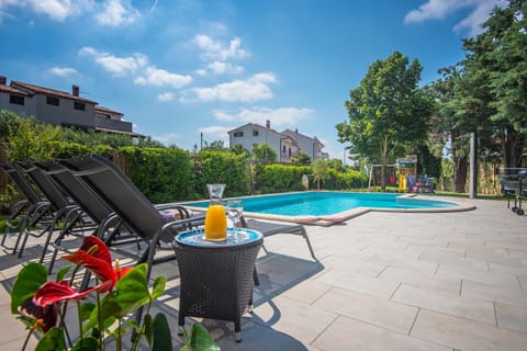 Villa Andrija Family Dream with heated pool at the sea with beautiful garden, outside cinema and kids playground Villa in Fažana