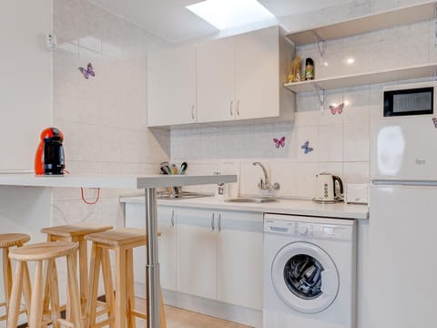 Photo of the whole room, Dining area, stove, toaster