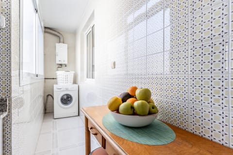 Kitchen or kitchenette, microwave, oven, stove, toaster, washing machine