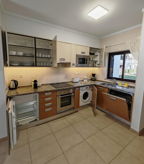 Kitchen or kitchenette, dishwasher, oven, toaster, washing machine, dryer