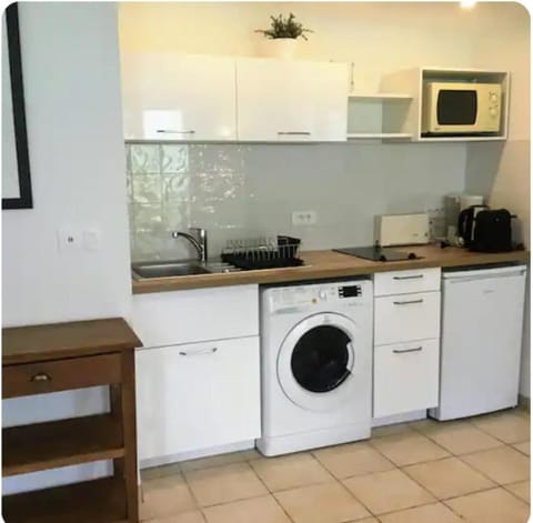 Kitchen or kitchenette, dishwasher, oven, stove, toaster, washing machine, dryer