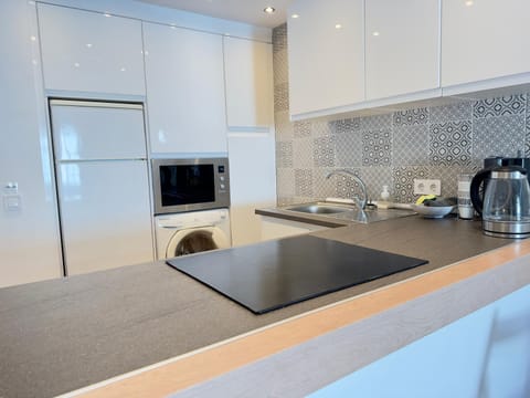 Coffee/tea facilities, Kitchen or kitchenette, furniture, microwave, oven, stove, toaster, washing machine, kitchen, air conditioner