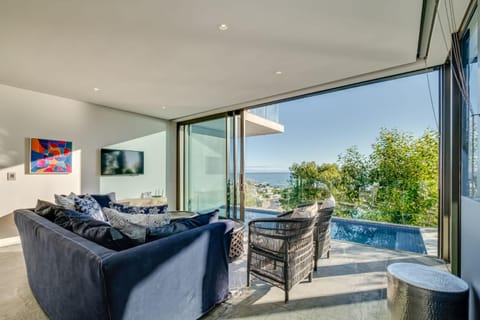 View (from property/room), Balcony/Terrace, Living room, Seating area, Pool view, Swimming pool