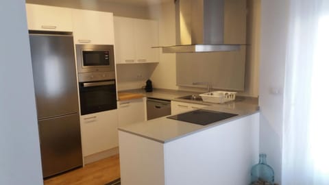 Kitchen or kitchenette, dishwasher, oven, stove