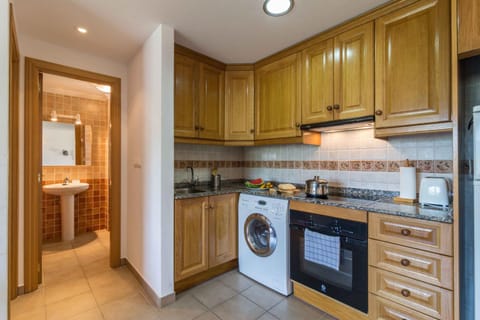 Kitchen or kitchenette, oven, stove, toaster, washing machine