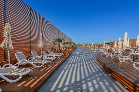 Property building, Day, Pool view, sunbed, towels